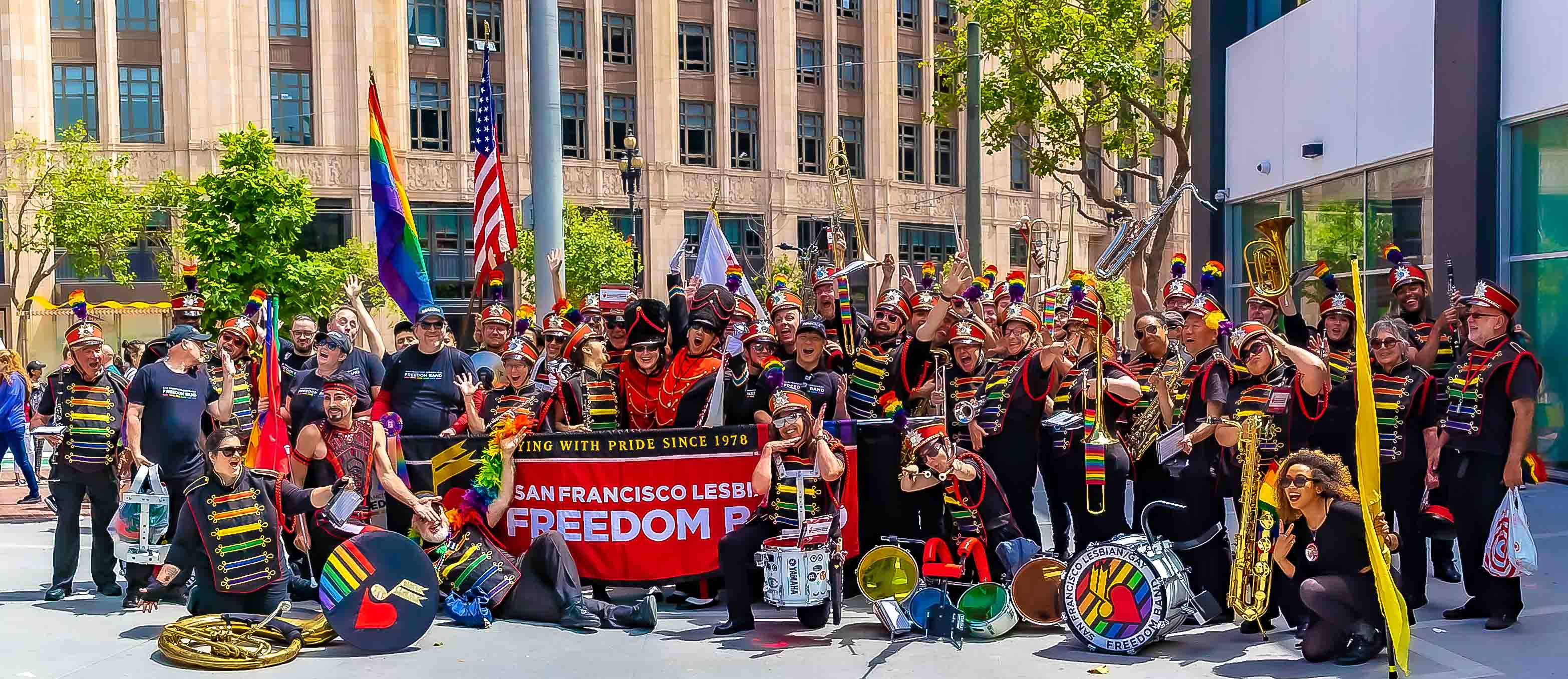 Freedom Band along the parade route — crowd cheering from the sidewalks